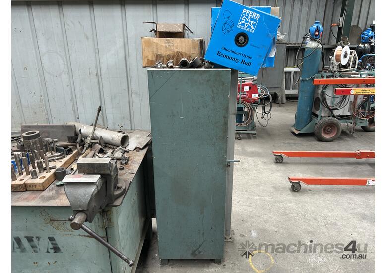 caption Steel Fabricated Workbench With Vice + Adjacent Storage Cabinet