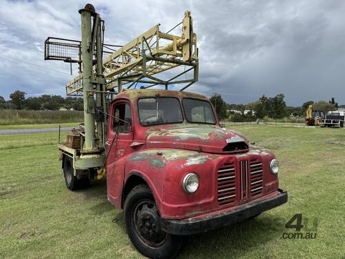 caption Austin K2 Loadstar MK2 4x2 2 Tonne Tabletop with Drilling Rig/Borer Unit on Tray Truck.