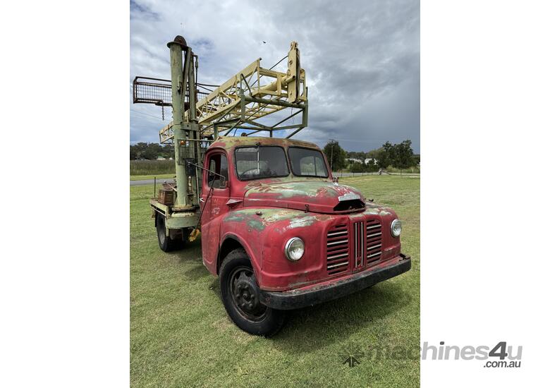 caption Austin K2 Loadstar MK2 4x2 2 Tonne Tabletop with Drilling Rig/Borer Unit on Tray Truck.