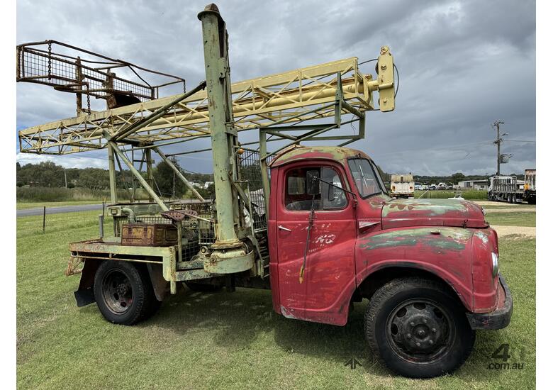 caption Austin K2 Loadstar MK2 4x2 2 Tonne Tabletop with Drilling Rig/Borer Unit on Tray Truck.