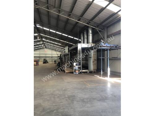 Two stainless steel spray booths with overhead chain conveyor & heated section