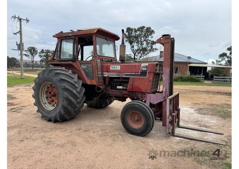 caption International 766 Tractor, Forklift Attachment and Post Hole Digger