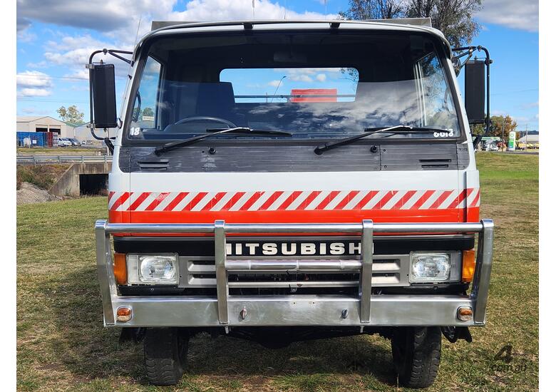 caption Mitsubishi Fuso Canter 4x4 Single Cab Firetruck. Ex NSW Rural Fire Service.
