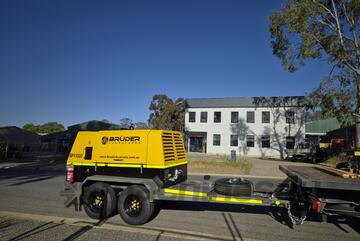 388CFM Diesel-Powered Rotary Screw Compressor with Safety Features, Mounted on Heavy-Duty Trailer