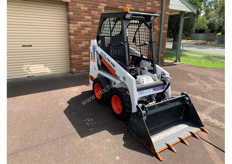 caption 2019 Bobcat Skid Steer – 64 Hours, 4-in-1 Bucket, Great Condition, with Trailer! - Hire