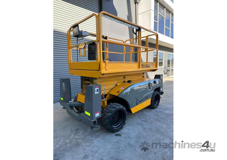 caption Haulotte Compact 12DX - 32ft Rough Terrain Scissor Lift