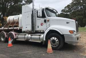 2007 International Eagle and 2010 Bailey Bodybuilders TRI350 tri axle drop deck trailer
