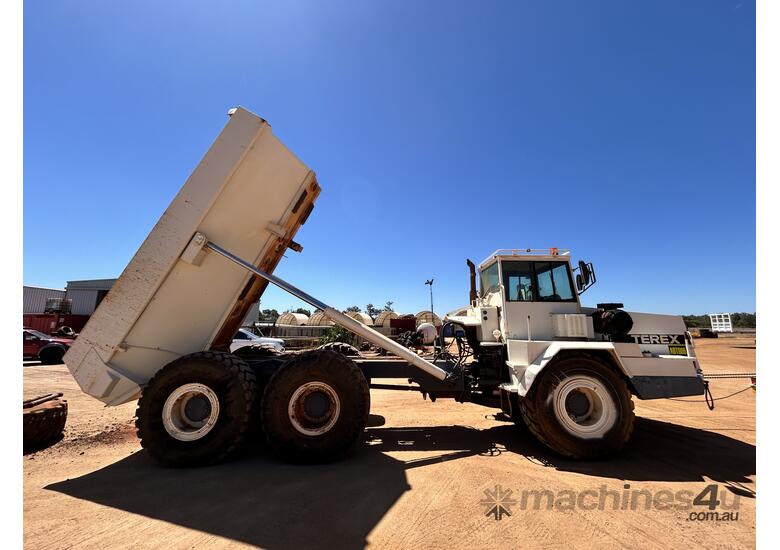 caption TEREX AT25 Articulated Dump Truck With Spare Truck