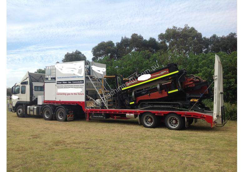caption Ditch Witch JT3020 All Terrain Horizontal Directional Drill and Volvo Semitrailer