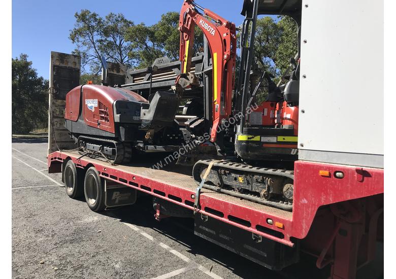 caption Ditch Witch JT3020 All Terrain Horizontal Directional Drill and Volvo Semitrailer