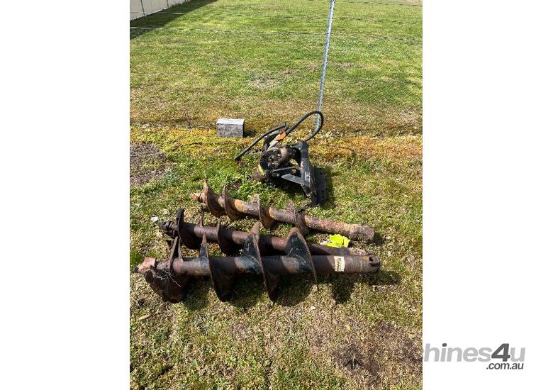 caption Posthole digger attachment suited for a Dingo