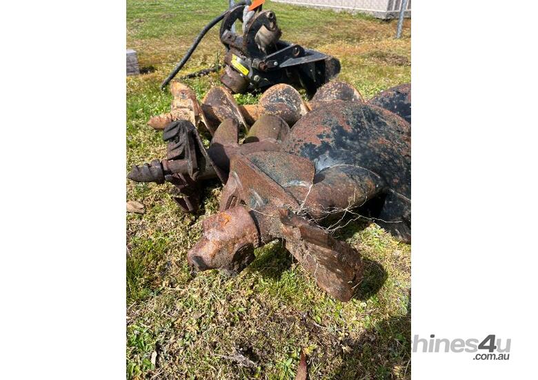 caption Posthole digger attachment suited for a Dingo