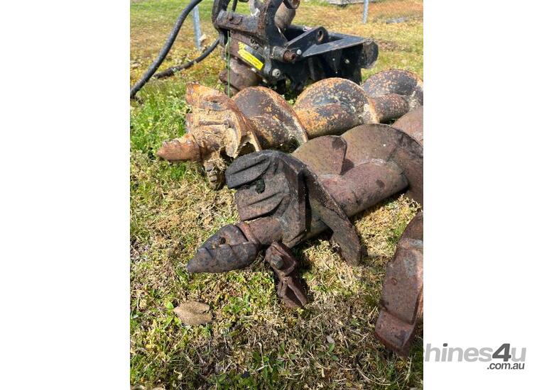 caption Posthole digger attachment suited for a Dingo